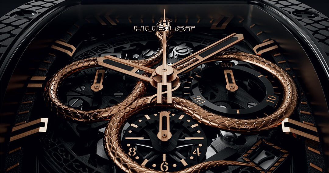 Close-up of a luxury Hublot watch, celebrating the Spirit of Big Bang with a gold serpent design intricately intertwined with the watch hands and dials, set against a dark, elaborate background.