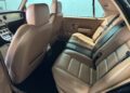The interior of the Bentley Turbo RT Mulliner exudes power and luxury, featuring beige leather seats with two front seats and a spacious three-seat rear bench with seatbelts. The elegant dashboard complements the light blue window, making this rare masterpiece truly stand out.