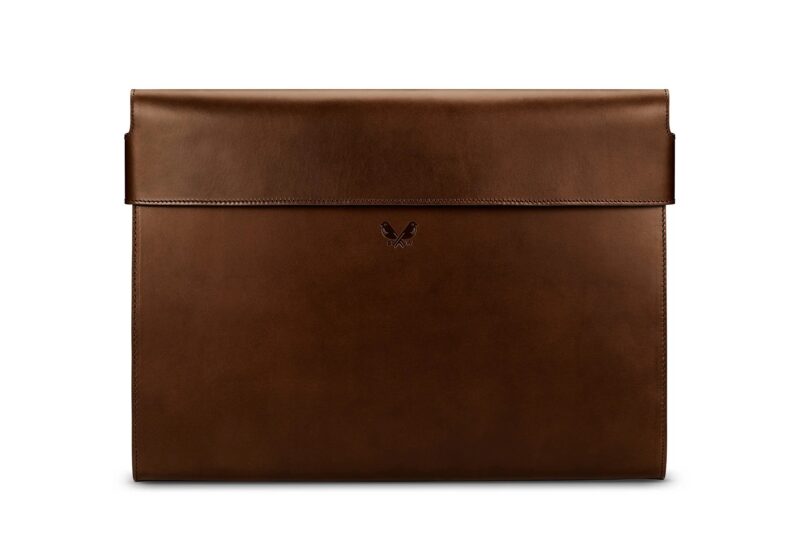 A luxurious brown leather laptop sleeve with a flap closure and a small, embossed design in the center, perfect for those who appreciate fine accessories.