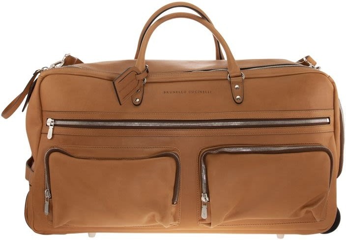 Discover a style upgrade with this tan leather duffel bag, featuring two front zippered pockets, dual handles, and a detachable shoulder strap. Accented with silver-colored zippers and hardware, it's the perfect luxury accessory now available for sale.