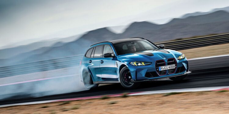 The new BMW M3 gracefully drifts on the racetrack, leaving a mesmerizing smoke trail with majestic mountains in the background.