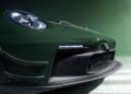 Close-up of a sleek green Porsche 911 GT3 RS front, featuring a prominent headlight, aerodynamic fins, and a tow hook.