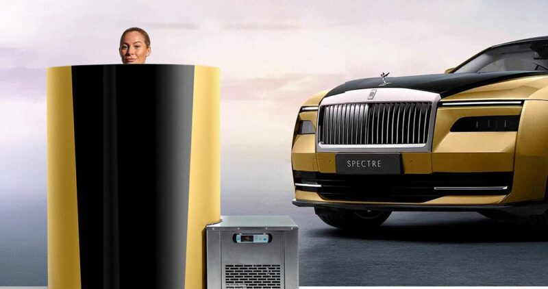 A person is partially submerged in a cryotherapy machine beside a gold and black luxury car named "Spectre," embodying an opulent lifestyle.