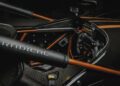 Close-up of a race car cockpit featuring a steering wheel, digital display, and "Radical" branding, celebrating Radical Motorsports' 28th Anniversary with sleek black and orange accents.
