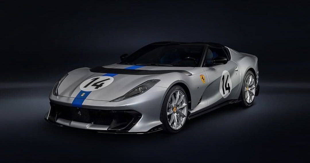 A gray Ferrari 812 Competizione with blue racing stripes and the number 14 on its hood and sides, tailor-made for speed, is set against a dark background.