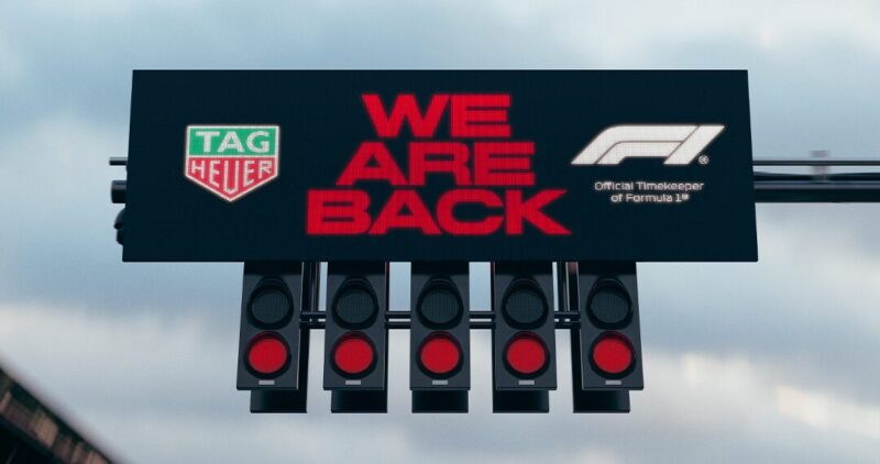 A Formula 1 starting light panel displays "We Are Back," exemplifying the luxury lifestyle alongside logos for TAG Heuer and Formula 1.