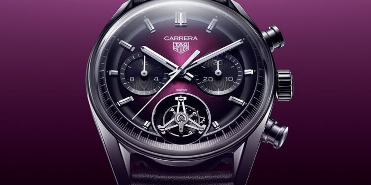 A TAG Heuer Carrera watch with a dark face, three subdials, visible mechanics at the bottom, and a black leather strap set against a purple gradient background, capturing the essence of LVMH Watch Week's celebration of exquisite watches.