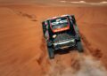The Dacia Sandriders tear through the red desert sand at the 2025 Dakar Rally, leaving a trail of dust as they gear up for victory.