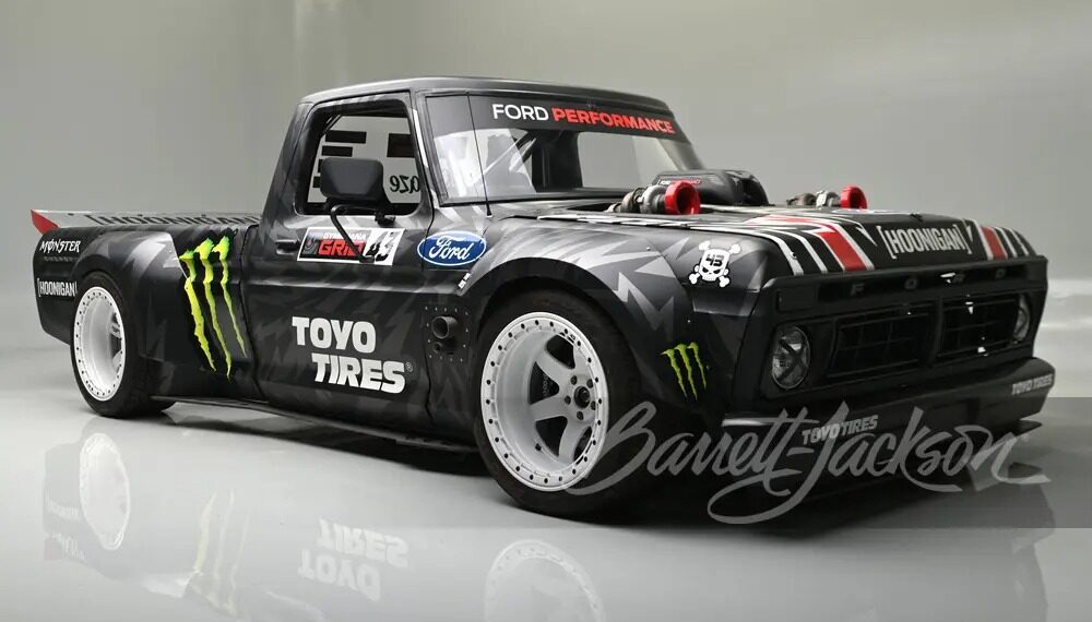 A custom black Ford F-150, known as the Hoonitruck, boasts 917HP with Ford branding and Toyo Tires logo. It features wide tires, a low body stance, and eye-catching decals, including Monster Energy logos.