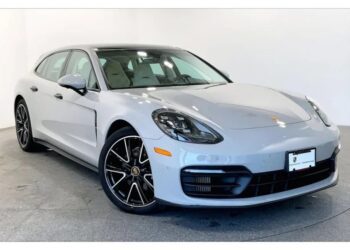 A silver Porsche Panamera parked indoors, angled to show the front and driver's side, with black multi-spoke wheels and a visible front license plate holder—an outstanding choice among Luxury Performance Wagons.
