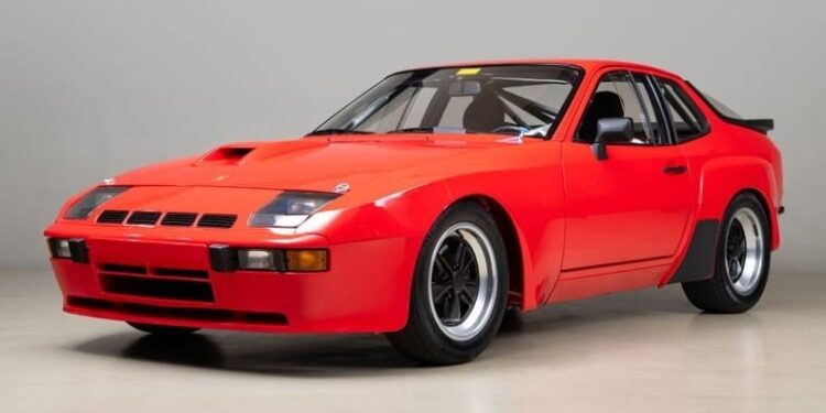 A classic Porsche sports car with black accents and wide tires is parked indoors, facing slightly left against a plain background—a standout choice for any Porsche investment.