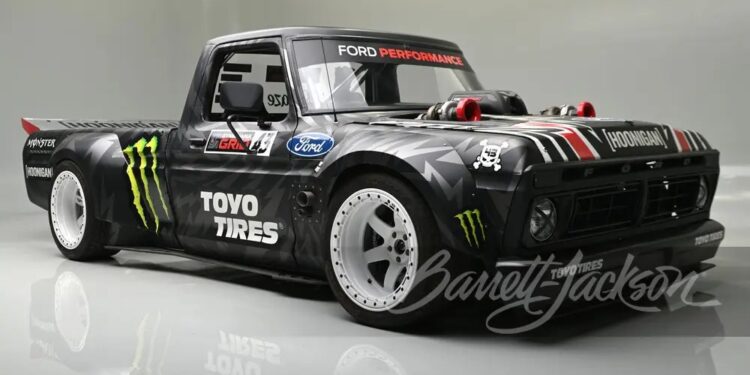 A custom black Ford F-150, known as the Hoonitruck, boasts 917HP with Ford branding and Toyo Tires logo. It features wide tires, a low body stance, and eye-catching decals, including Monster Energy logos.