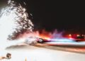 A Porsche Taycan drifts on a snowy track at night, setting the scene for an epic ice drifting session. As the car emits smoke and is illuminated by bright fireworks, it feels like a moment worthy of a Guinness World Record.