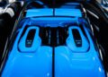 A close-up of a blue Bugatti engine showcases the iconic "W16" and "1600" labels, as seen in the newly unveiled W16 Mistral.