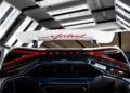Bugatti unveils the W16 Mistral in a spectacular display under bright lights, highlighting its red taillights, sleek white spoiler, and iconic Bugatti logo.