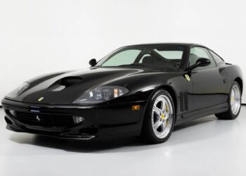 A black Ferrari 550 Maranello, renowned among exotic cars for its V12 engine, is parked in a white studio setting, viewed from the front left angle.
