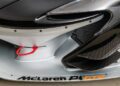 Close-up of a McLaren P1 GTR car front, showcasing its sleek aerodynamic features, mesh grille, and red tow hook—a perfect specimen among track-only hypercars.