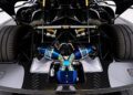 Close-up view of a Koenigsegg Agera RS engine bay, featuring exposed mechanical components, carbon fiber details, and blue metallic exhaust in this high-performance vehicle.