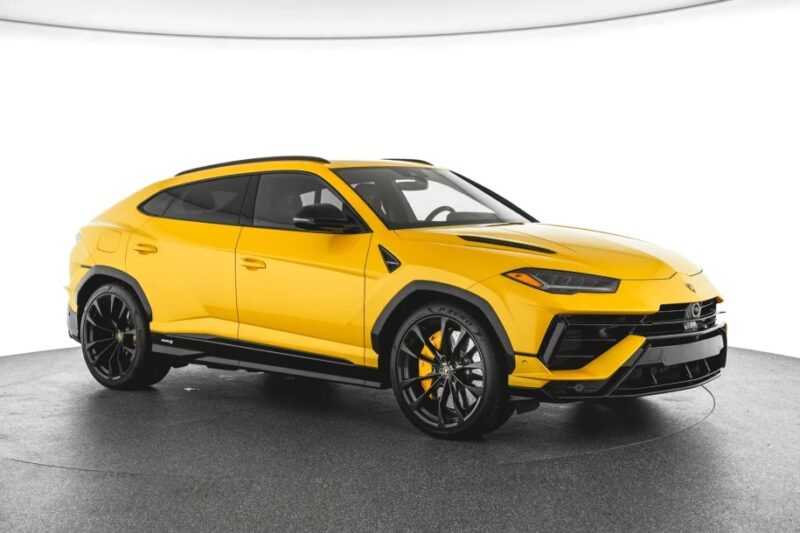 Bright yellow luxury Lamborghini Urus with black accents, large wheels, and sleek design, shown in a well-lit studio. This stunning model represents one of the best Lamborghinis available today.