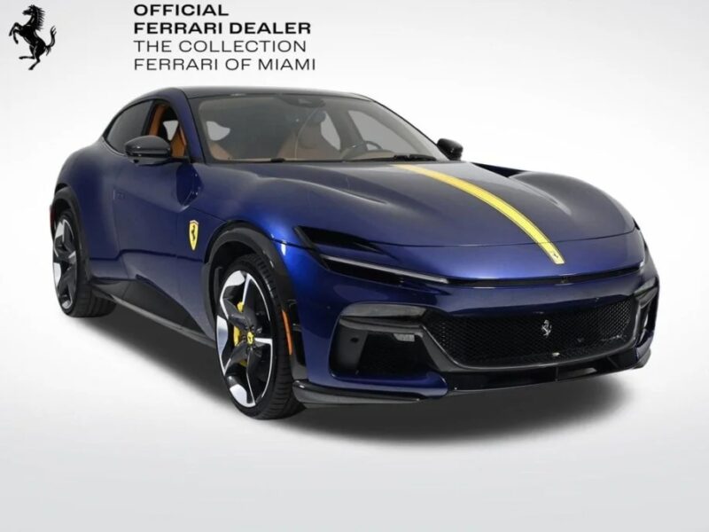 Blue Ferrari sports car with a yellow stripe down the center, displayed on a white background. Text in the corner reads "Official Ferrari Dealer The Collection Ferrari of Miami." Explore more iconic models like the Ferrari Purosangue SUV for sale today.