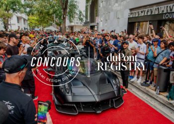 A luxury car graces the red carpet, drawing thousands in the Miami Design District during the Miami Concours 2025. The "Miami Concours" and "duPont Registry" logos appear, highlighting this supercar art event.