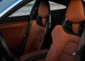 The interior of this luxury Porsche car features rich brown leather seats and a sleek design, exuding timeless elegance.