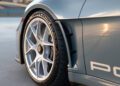 Close-up of a Porsche 911 S/T's rear wheel, highlighting the white-spoked rim, Michelin tire, and aerodynamic fender detail. This exquisite model will soon be featured at RM Sotheby's prestigious auction.