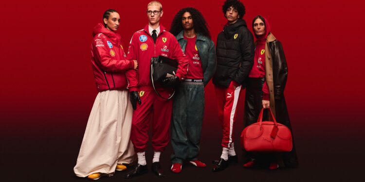 Five people in Ferrari-branded red outfits stand against a solid red background, showcasing the 2025 Replica Collection. This exclusive line, part of the PUMA x Scuderia Ferrari collaboration, highlights jackets, pants, and accessories to celebrate their 20th Anniversary in style.