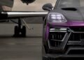 A sleek black Porsche Cayenne with purple accents, enhanced by TECHART's MAGNUM package, is elegantly parked on a tarmac near a private jet.