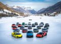 A collection of luxury Lamborghini sports cars is elegantly arranged on the snow-covered landscape of Livigno, with majestic mountains and serene trees in the background, offering an exhilarating snow driving experience.