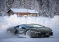 A Lamborghini bursts through the snowy landscape, effortlessly navigating the pristine white terrain of Livigno with towering trees and a cozy cabin in the background, capturing the ultimate Snow Driving Experience.