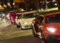 A lineup of brightly colored Lamborghini sports cars, including rare Polo Storico models, is parked along a street at night.