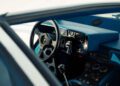 The interior view of this classic Lamborghini showcases a steering wheel adorned with the iconic logo, complemented by a gear shift and dashboard that exude timeless elegance, set against luxurious blue upholstery—a true testament to Polo Storico's dedication to automotive heritage.