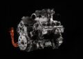 Close-up of a complex Lamborghini engine against a black background, highlighting intricate machinery and the orange cables of the 900HP Powertrain.