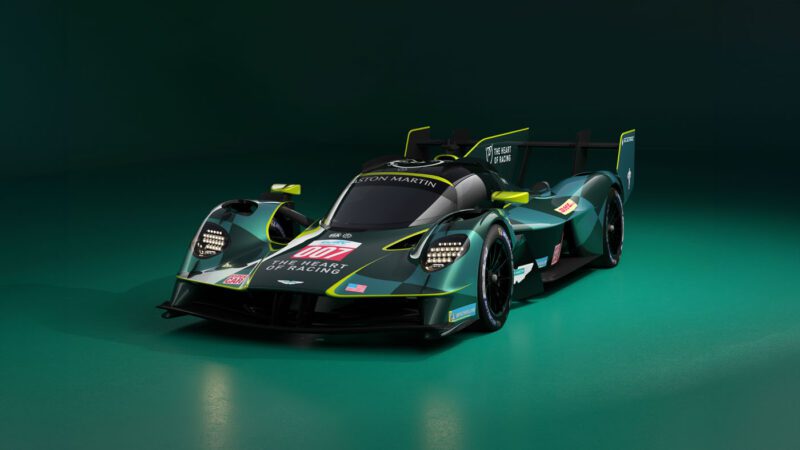 A sleek, dark green Aston Martin Valkyrie Hypercar with "007" on the front, designed for speed and precision racing, displayed against a dark background reminiscent of Le Mans.