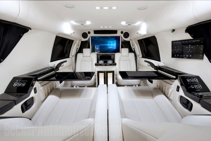 Experience a luxurious vehicle interior featuring custom white leather seats, advanced digital screens, and a central control panel, all contributing to a truly unique creation.