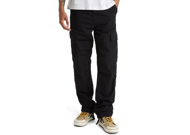 Person wearing black cargo pants, white shirt, and white sneakers with yellow laces stands facing forward against a white background—a perfect Wheels x Wardrobe look.