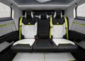 The custom Tesla Cybertruck features a futuristic car interior with three sporty seats, black and white upholstery, neon green accents, and a sleek, modern design.