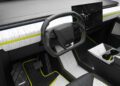 The futuristic car interior, inspired by a custom Tesla Cybertruck, boasts a sleek steering wheel, expansive digital display, and a black-and-white dashboard with Mansory-style neon green accents.