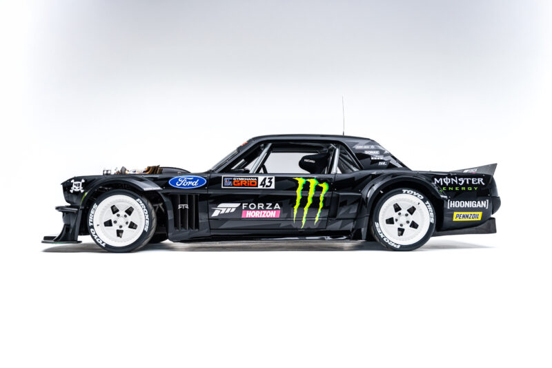 A sleek black custom car with prominent logos including Ford, Monster Energy, and Forza. It has a low, aerodynamic profile and white wheels.