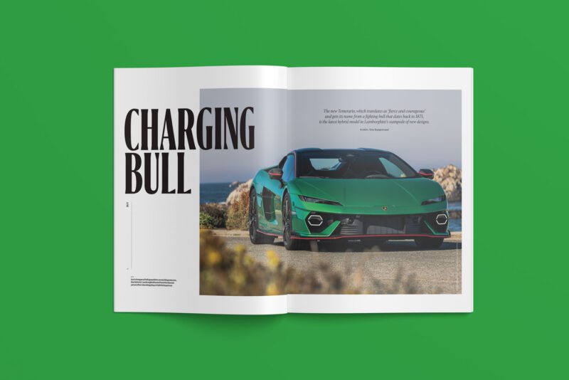 An open magazine, duPont REGISTRY March 2025 edition, displays an article titled "Charging Bull" with a green sports car majestically parked on a road lined with trees, all set against a vibrant green background.