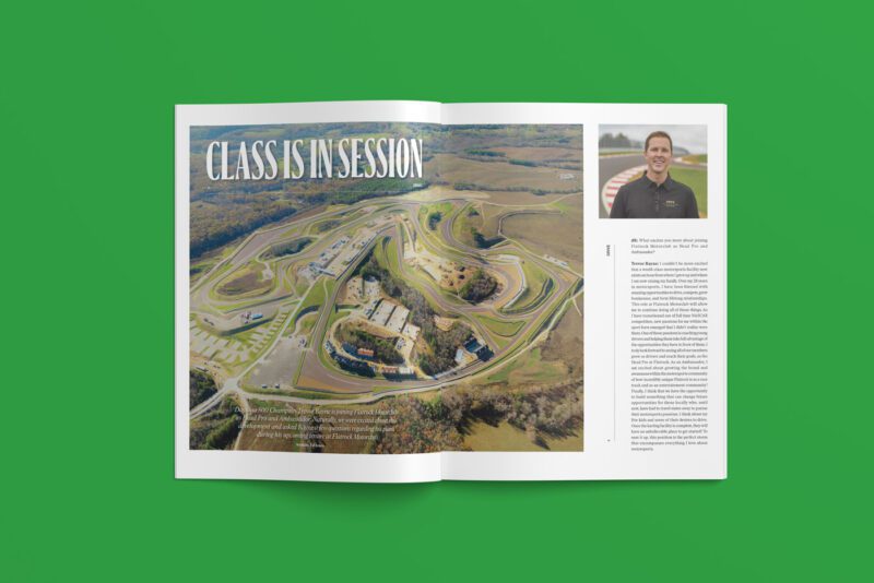 Open duPont REGISTRY magazine on a green surface, revealing an aerial view of a racetrack on the left and a smiling man with text on the right, set for March 2025.