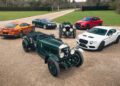 A group of six vintage and modern cars, including a Bentley Speed Six Continuation Series, is beautifully displayed on a gravel path surrounded by grass, each vehicle telling its own special story.