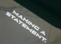 Text "MAKING A STATEMENT." projected on a marble surface, embodying the bold spirit of TECHART and reminiscent of the sleek design found in a Porsche Cayenne.
