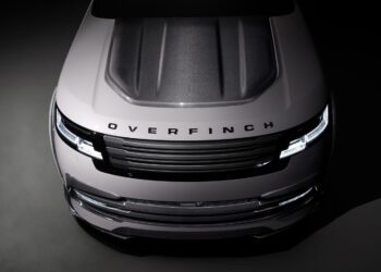 Top view of a silver vehicle with a carbon fiber hood, showcasing the "Overfinch" branding on the front. The design embodies a powerful aesthetic, characteristic of the Velocity Edition.