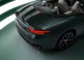 A dark green Maserati GranCabrio with visible taillights and a "GranCabrio" badge on the rear is parked indoors at I.C.E. St. Moritz. The light beige interior contrasts beautifully as the focus remains on the rear and part of the driver's side.