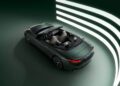The Maserati GranCabrio in dark green is parked in a studio, set against three illuminated horizontal lines on a green background. The car's beige interior complements its sophisticated appearance perfectly.