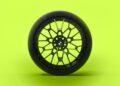 The sleek black car wheel with its intricate spoke design stands out against a bright green background, evoking the dynamic spirit of the BMW M4 CS.