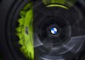 Close-up of a spinning BMW M4 CS wheel with the iconic logo at the center and a yellow brake caliper featuring an "M" emblem, reminiscent of Valentino Rossi's dynamic flair as he celebrates his 46th birthday.