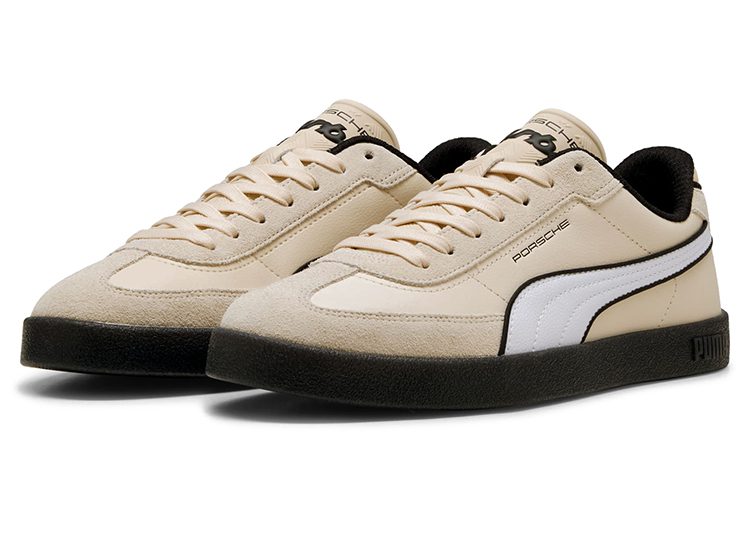 A pair of beige PUMA sneakers with white side stripes, black soles, and "Porsche" branding on the side and tongue, offering an automotive-inspired look for the modern driver.